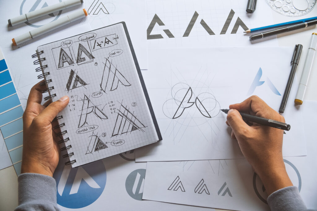 Graphic designer development process drawing sketch design creative Ideas draft Logo product trademark label brand artwork. Graphic designer studio Concept.